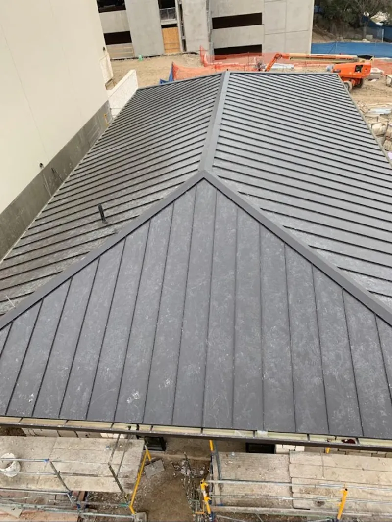 Commercial metal roof construction with crane equipment in Fairlawn